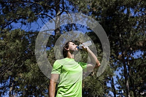 Thirsty athlete drinking water after workout