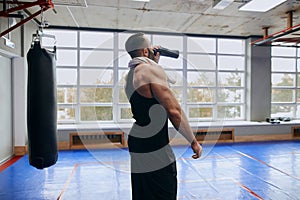 Thirsty athlete enjoying drinking cold water