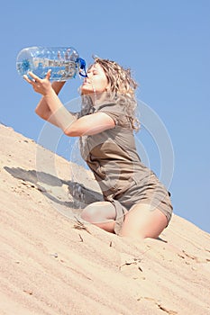 Thirsty blond woman on desert