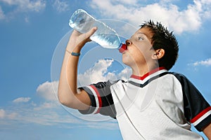 Thirsty boy drinking water out