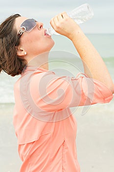 Thirsty brunette at the beach
