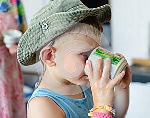 Thirsty Cute Young Boy Drinking Water on a Glass