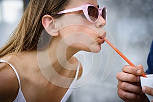 Thirsty for a drink. Cute woman drink through straw. Pretty woman sip beverage with drinking straw. Fashionable woman