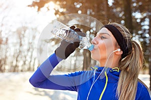 Thirsty female athlete drinking water