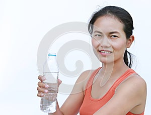 Thirsty fitness girl drinking bottle of water