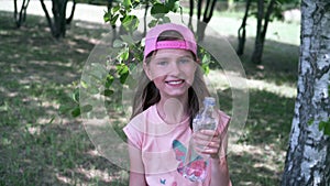 Thirsty girl drinking water out of a plastic bottle