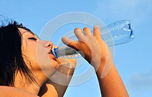 Thirsty girl drinks cold water in hot day