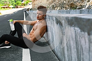 Thirsty Hot Man With Water Resting After Running Workout. Sports