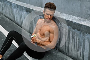 Thirsty Hot Man With Water Resting After Running Workout. Sports