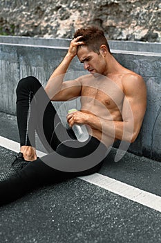 Thirsty Hot Man With Water Resting After Running Workout. Sports