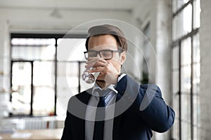 Thirsty male employee drink clean mineral water