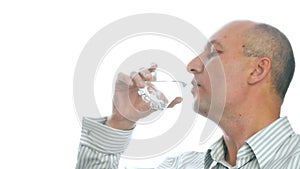 Thirsty man drinking cold water from glass on white background isolated