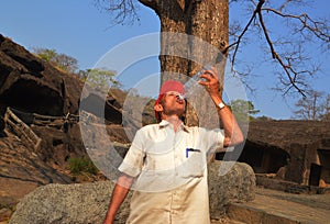 A thirsty man drinking water by bottle