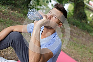 Thirsty man drinking water after match