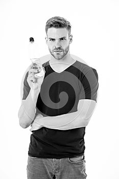 Thirsty man hold bottle of water isolated on white background. Bearded man with beard in tshirt with plastic bottle