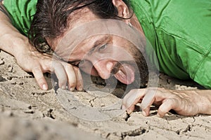 Thirsty man on parched soil