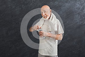 Thirsty senior man drinking water from bottle