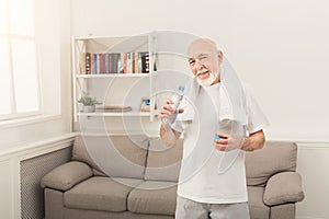 Thirsty senior man drinking water from bottle