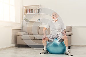 Thirsty senior man having rest after training