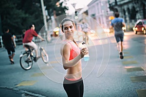 Thirsty sportswoman drinking water