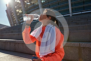 Thirsty sporty woman drink water after workout