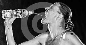 Thirsty Sporty Woman Drinking Water from a Bottle