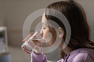 Thirsty teenage girl drink clean water at home