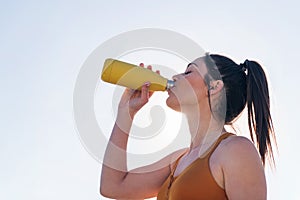 thirsty and tired runner drinking water outdoors