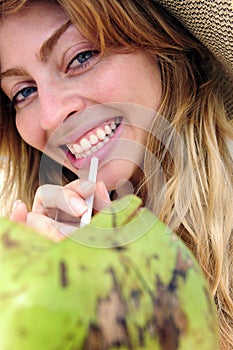 Thirsty woman drinking coconut water, close-up