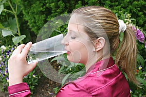 Thirsty woman drinking water.