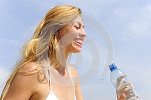 Thirsty woman drinking water outdoors