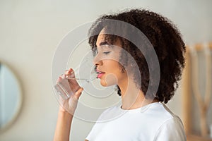 Thirsty woman holds glass drinks still water preventing dehydration