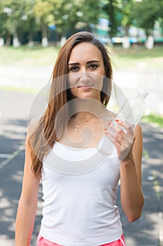 Thirsty woman holds water bottle. Thirst and water balance concept. Signs you definitely need pay attention your body