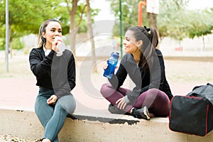 Thirsty women in their 30s resting after working out