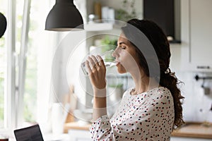 Thirsty young woman drink clean mineral water