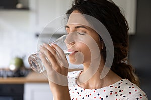 Thirsty young woman drink water from glass