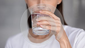 Thirsty young woman drinking pure mineral water