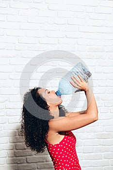 Thirsty Young Woman Drinking Water From Plastic Bottle For Health