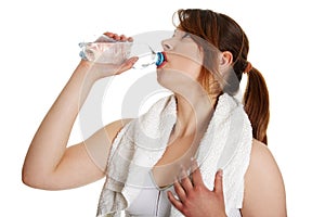 Thirsty young women drinking water after fitness