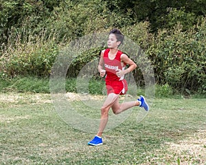 Thirteen year-old Amerasian boy running cross country race