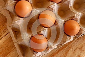 Thirty brown chicken eggs in a cardboard tray packaging. Raw fre