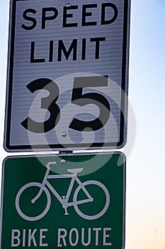 Thirty five an hour speed limit sign, and a bike route sign