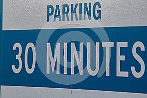 Thirty minute parking sign stating limits for parking on private property