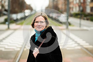 Thirty year old woman posing on the lightrail tramway tracks