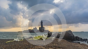 Thiruvalluvar Statue with Flowers in foreground photo