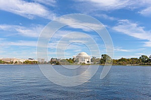 Thomas Jefferson Memorial surrounded by trees around the Tidal Basin in autumn foliage.