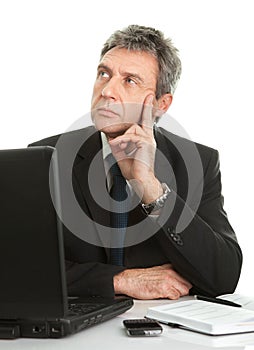 Thoughful business man working on laptop