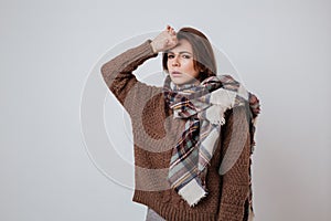 Thoughful woman in sweater and scarf