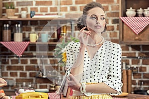 thoughtful adult housewife in vintage clothes looking away