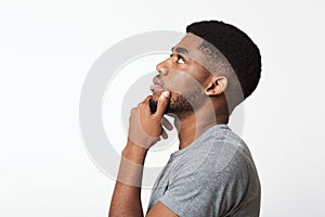 Thoughtful african-american man profile portrait on white